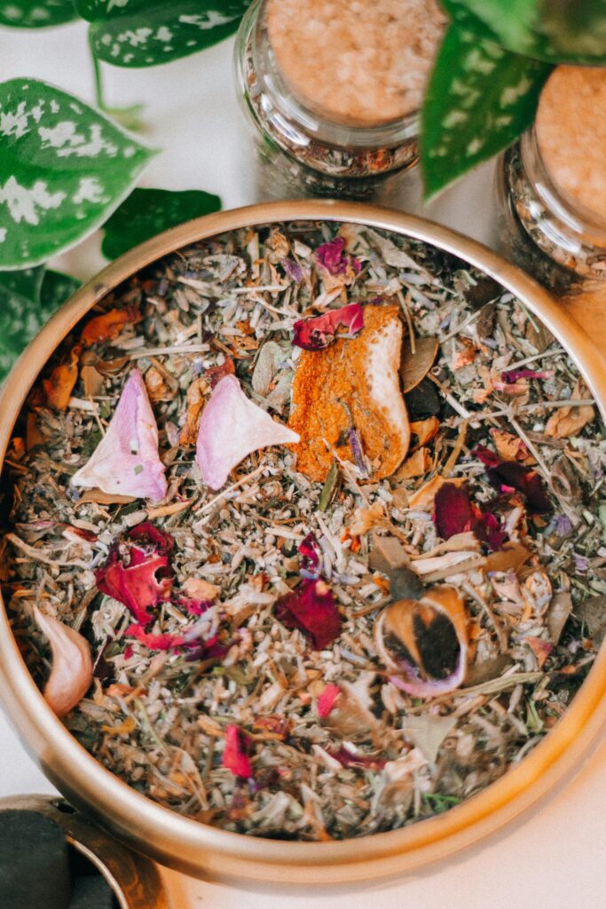 pexels-photo-11531905-11531905 Close-up of a colorful mix of dried herbs and flowers in a decorative bowl for incense or aromatherapy.